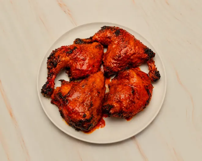 A whole peri peri chicken, jointed into four flame-grilled pieces